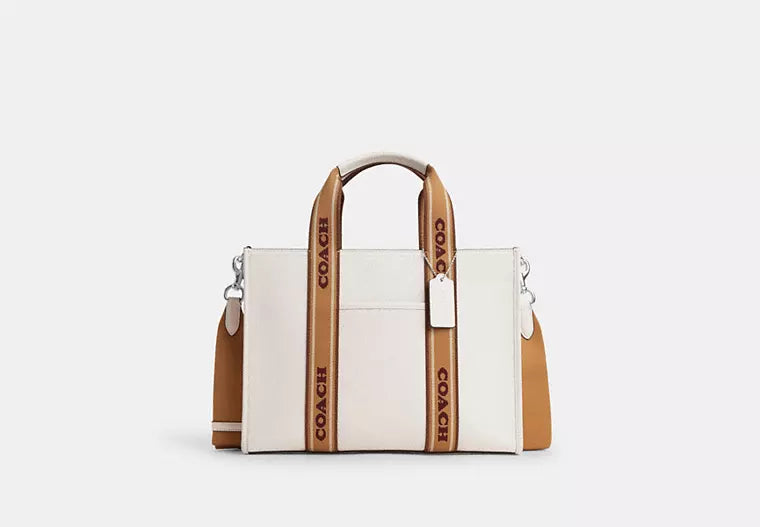 Coach tote bags with a snap - button closure and a decorative charm for styleCoach Smith Tote